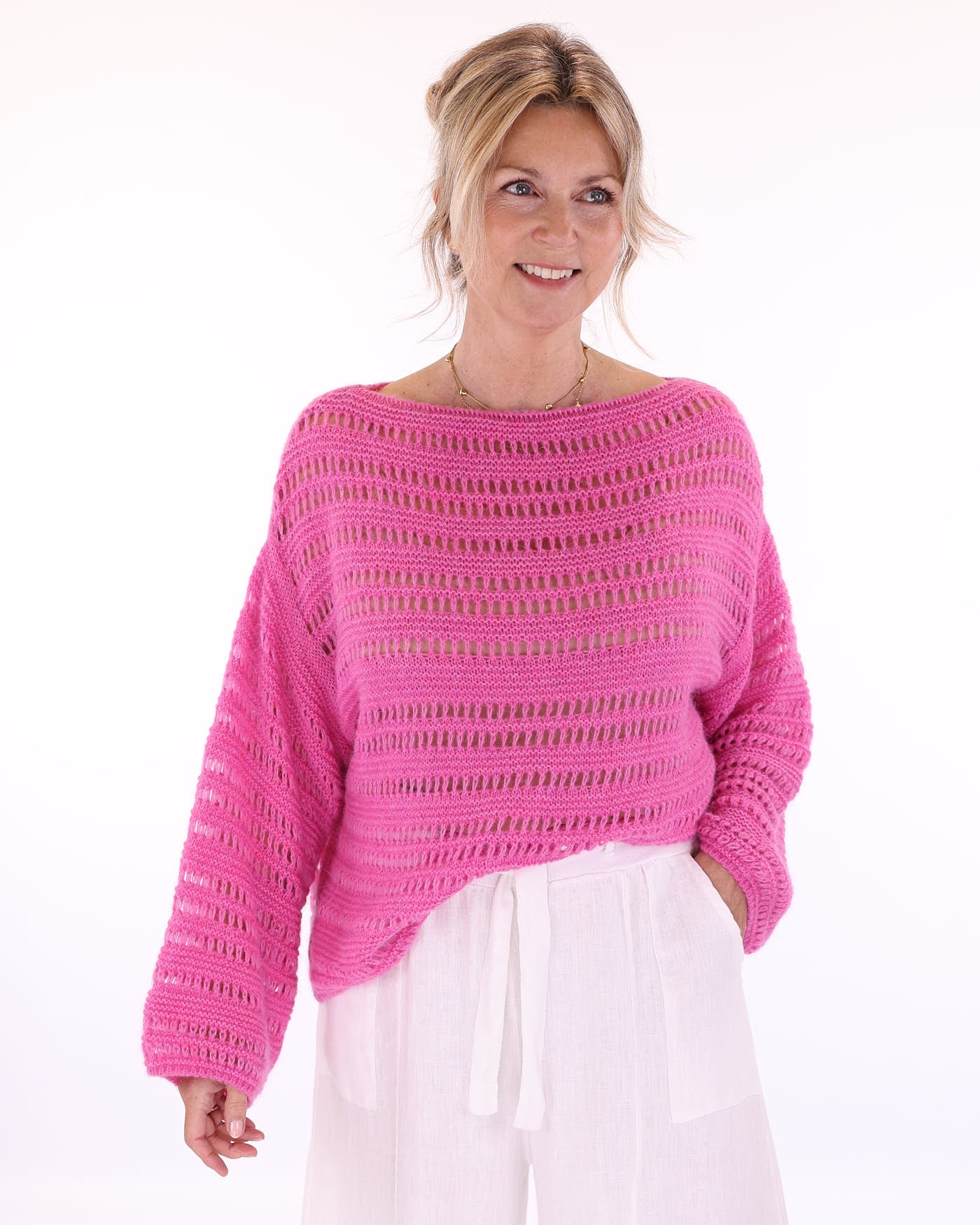 Women's alpaca blend fuchsia pink crochet style long sleeve jumper on a white background, made in Italy