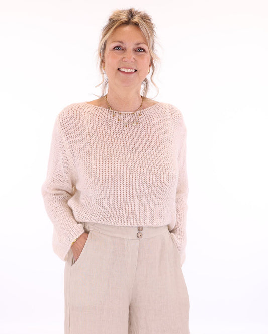 Women's long sleeve cobweb knitted alpaca blend sweater in cream, worn with cream linen  trousers, made in Italy