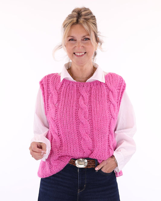 Women's alpaca blend cable knit tank top for Spring/Summer in fuchsia pink, worn over a white long sleeve shirt with a collar, made in Italy