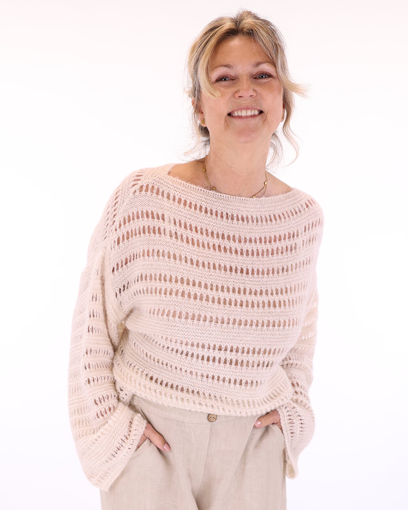 Women's alpaca blend light pink crochet style long sleeve jumper on a white background, made in Italy